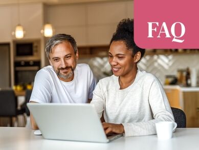 Couple reviewing information together on a laptop at home