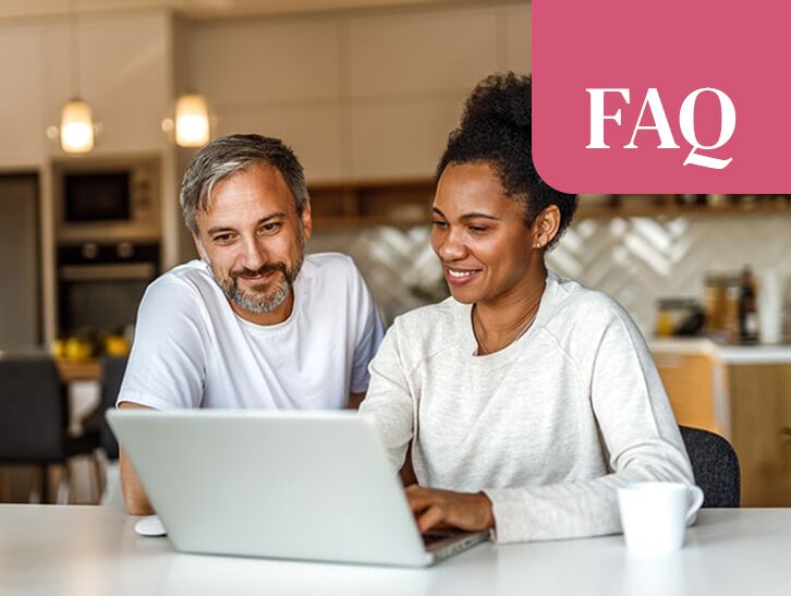 Couple reviewing information together on a laptop at home