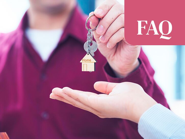 Close-up of home keys being handed to a buyer