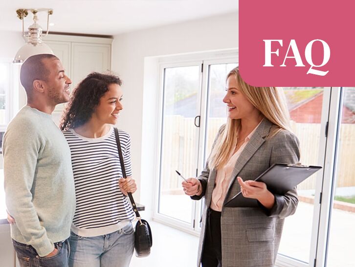 Real estate agent speaking with prospective homebuyers inside a house