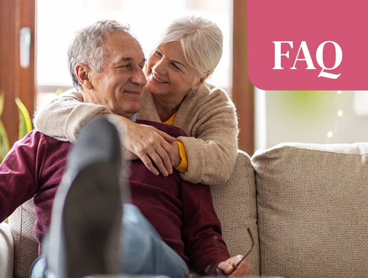 Senior couple smiling together in a comfortable living room